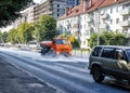 Cleaning machine washing the city asphalt road with water spray Royalty Free Stock Photo