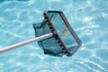 Cleaning swimming pool with net skimmer Royalty Free Stock Photo