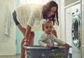 Cleaning, mother and baby playing in basket doing the laundry in their home. Hygiene or clean for wellness, positive and Royalty Free Stock Photo