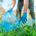 Cleaning nature by collecting plastic waste, plastic bottles from the drink cause an ecological disaster