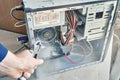 Cleaning an open dusty old computer with a compressed air gun Royalty Free Stock Photo