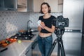 Cleaning the orange. Girl in the modern kitchen at home at her weekend time in the morning Royalty Free Stock Photo