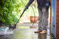 Cleaning patio paving with a high pressure washer the man is using the water to clean the garden path Royalty Free Stock Photo