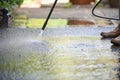 Cleaning patio paving with a high pressure washer the man is using the water to clean the garden path Royalty Free Stock Photo