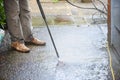 Cleaning patio paving with a high pressure washer the man is using the water to clean the garden path Royalty Free Stock Photo