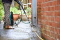Cleaning patio paving with a high pressure washer the man is using the water to clean the garden path Royalty Free Stock Photo