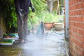 Cleaning patio paving with a high pressure washer the man is using the water to clean the garden path Royalty Free Stock Photo