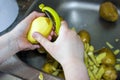 Cleaning potatoes. Hands close-up.