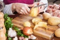 Cleaning potatoes at table