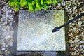 Cleaning with a pressure washer of granite garden slabs, washing with water under high pressure