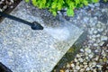 Cleaning with a pressure washer of granite garden slabs, washing with water under high pressure Royalty Free Stock Photo