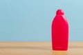 Cleaning product plastic container for house clean on wooden table and blue background Royalty Free Stock Photo