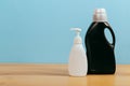 Cleaning product plastic container for house clean on wooden table and blue background Royalty Free Stock Photo