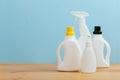 Cleaning product plastic container for house clean on wooden table and blue background Royalty Free Stock Photo