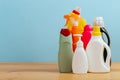 Cleaning product plastic container for house clean on wooden table and blue background Royalty Free Stock Photo