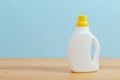 Cleaning product plastic container for house clean on wooden table and blue background Royalty Free Stock Photo