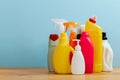 Cleaning product plastic container for house clean on wooden table and blue background Royalty Free Stock Photo