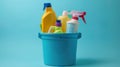 Cleaning products in bucket on blue background Royalty Free Stock Photo