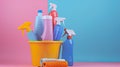 Cleaning products in bucket on blue and pink background Royalty Free Stock Photo