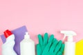 Cleaning products on a pink background. White bottles with detergents and cleaning products, sponges and gloves Royalty Free Stock Photo