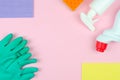 Cleaning products on a pink background. White bottles with detergents and cleaning products, sponges and gloves Royalty Free Stock Photo