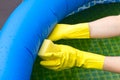 Cleaning pvc inflatable swimming pool, Cleaning the dirty empty pool of algae, The beginning of the swimming season in Royalty Free Stock Photo