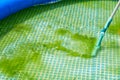 Cleaning pvc inflatable swimming pool, Cleaning the dirty empty pool of algae, The beginning of the swimming season in Royalty Free Stock Photo