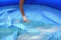 Cleaning pvc inflatable swimming pool, Cleaning the dirty empty pool of algae Royalty Free Stock Photo