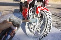 Cleaning red sportbike in the car wash
