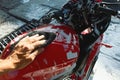 Cleaning red sportbike in the car wash