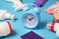 Cleaning service background with chemicals and red alarm clock. Saving time in house cleaning concept Royalty Free Stock Photo