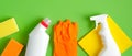 Cleaning service banner mockup. Flat lay house cleaning supplies on green background. Top view cleaner spray bottle, rag, sponge,