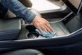 Cleaning service, car interior washing. Cropped close up image of male hand, washing a car interior with microfiber