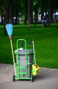 Cleaning service cart full of supplies and equipment along with grey trash bin Royalty Free Stock Photo