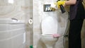 Cleaning service company. Cleaning chrome-plated button of toilet bowl in bathrooms, bidets. polishing handles. Cleaning