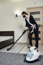 Cleaning service company employee removing dirt from carpet in flat with professional steam cleaner equipment Royalty Free Stock Photo