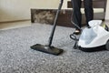 Cleaning service company employee removing dirt from carpet in flat with professional steam cleaner equipment close up Royalty Free Stock Photo