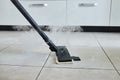 Cleaning service company employee removing dirt from carpet in flat with professional steam cleaner equipment close up Royalty Free Stock Photo