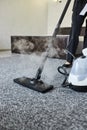 Cleaning service company employee removing dirt from carpet in flat with professional steam cleaner equipment close up Royalty Free Stock Photo