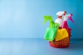 Cleaning service concept with supplies in basket over blue background with copy space Royalty Free Stock Photo