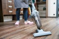 Cleaning service. the female cleaner vacuums the floor with a vacuum cleaner