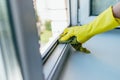 Cleaning service with gloves washes the window frame with a rag Royalty Free Stock Photo