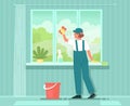 Cleaning service. A woman cleaner in uniform washes the window with detergent. House or apartment cleaning Royalty Free Stock Photo