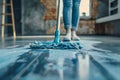 Cleaning Service Woman Mopping The Floor In Kitchen At Home