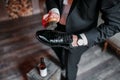 Cleaning shoes on wooden background. black shoe with a brush Royalty Free Stock Photo