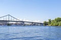 Scenic nature travel cityscape river Dnipro with blue water and metal pedestrian bridge at sunny summer day in Kiev.