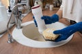 Cleaning sink in kitchen, Hand in gloves and sponge, detergent, dry powder. cozy interior of the home, restoring order,