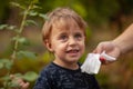 Cleaning smiling baby face and skin with wet wipes Royalty Free Stock Photo