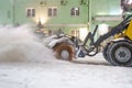 Cleaning snow from road. Snowplow tractor in city blow snow from street for transport traffic safety Royalty Free Stock Photo