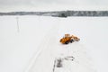 cleaning snow from the streets after a heavy snowfall. Tractor cleans the snow-view from the top